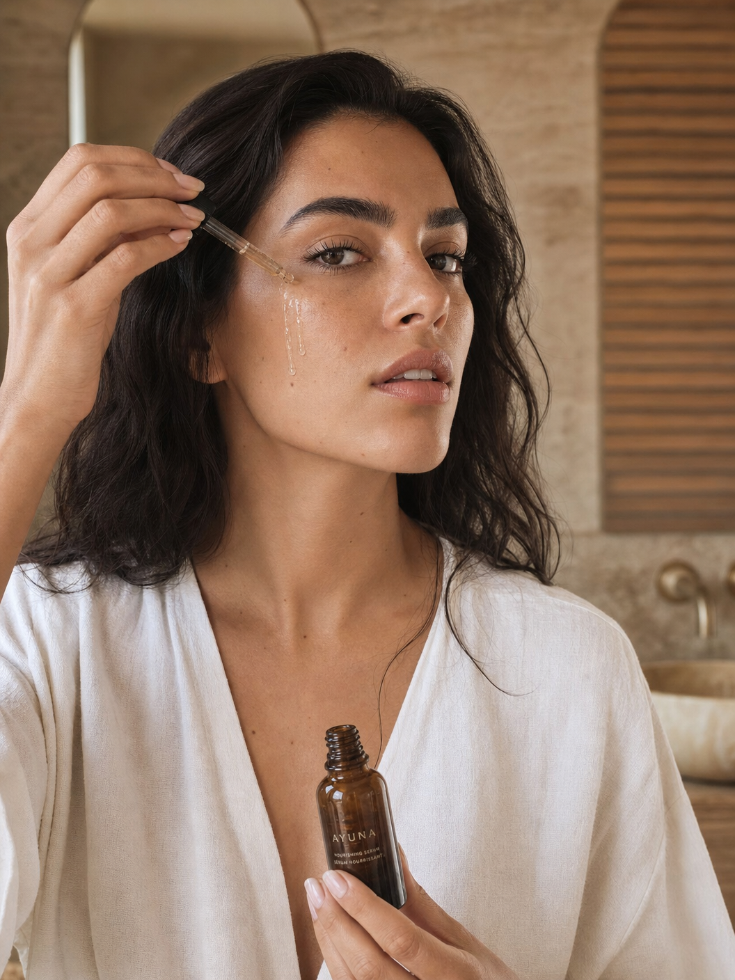 Young Latina woman applying wellness serum in minimalist bathroom